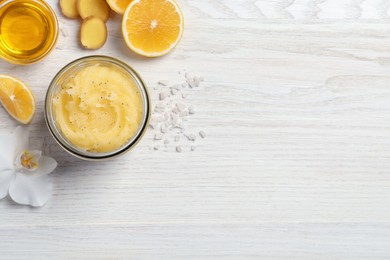 Photo of Flat lay composition with body scrub in glass jar on white wooden table, space for text