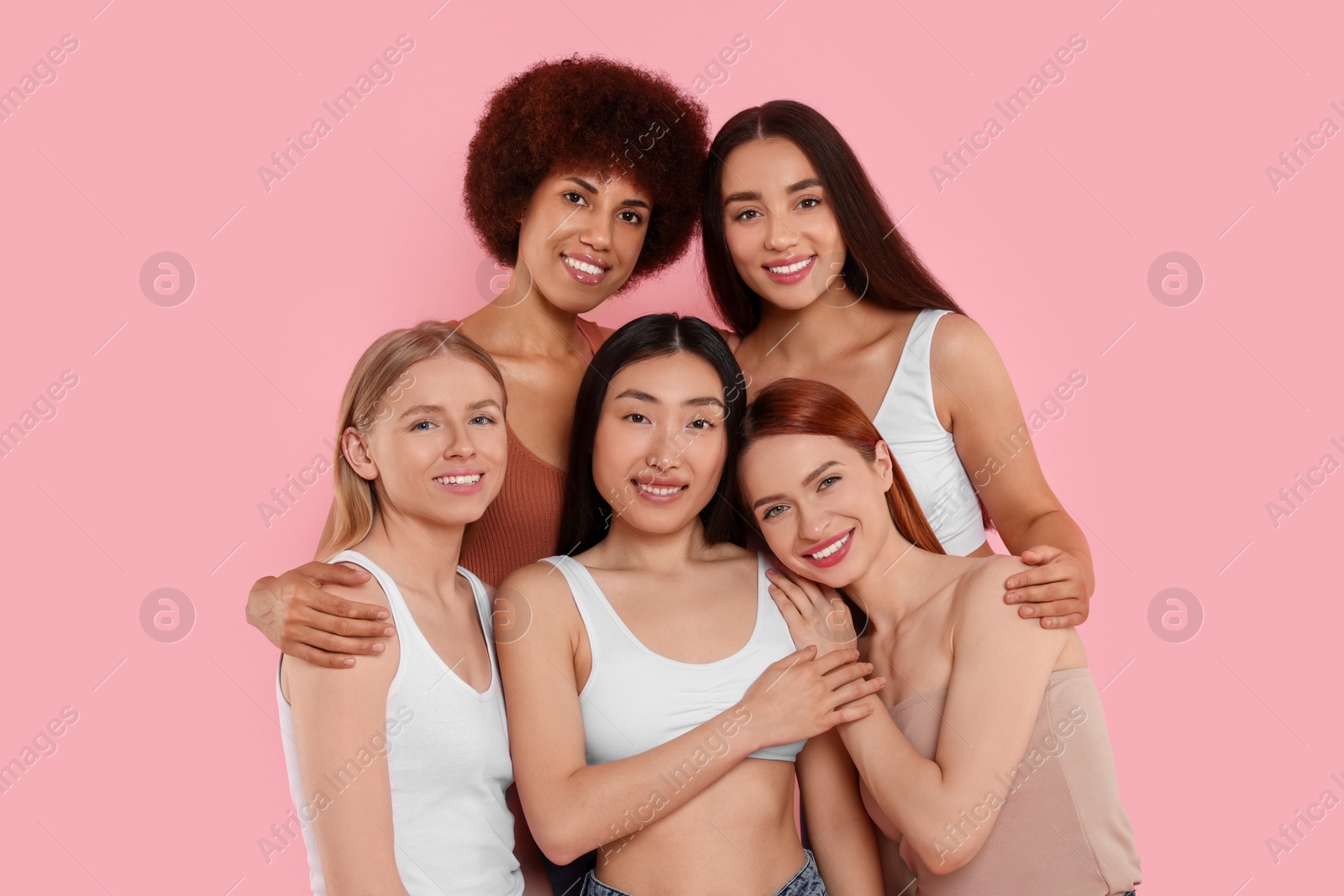 Photo of Portrait of beautiful young women on pink background