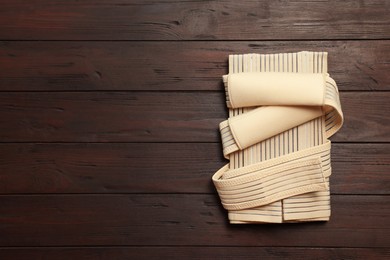 Photo of Beige posture corrector on wooden table, top view. Space for text