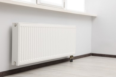 Photo of Modern radiator in room. Central heating system