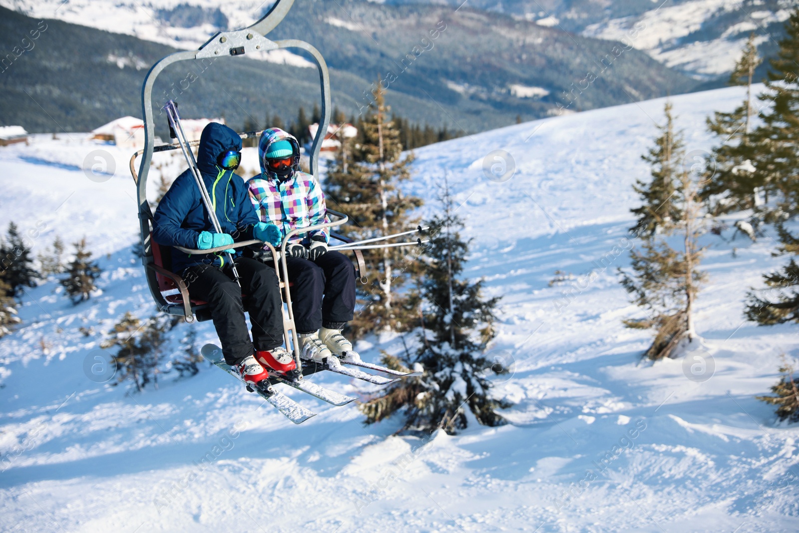 Photo of People using chairlift at mountain ski resort, space for text. Winter vacation