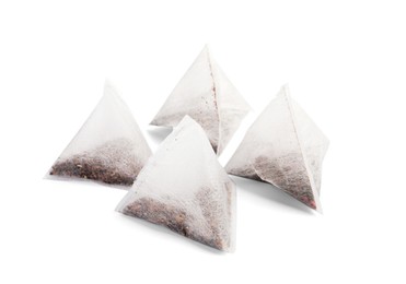 Photo of Many new pyramid tea bags on white background