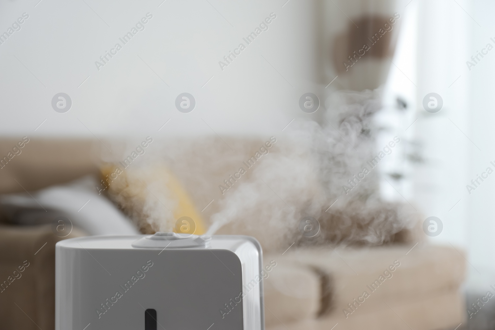 Photo of Modern air humidifier indoors, closeup. Space for text