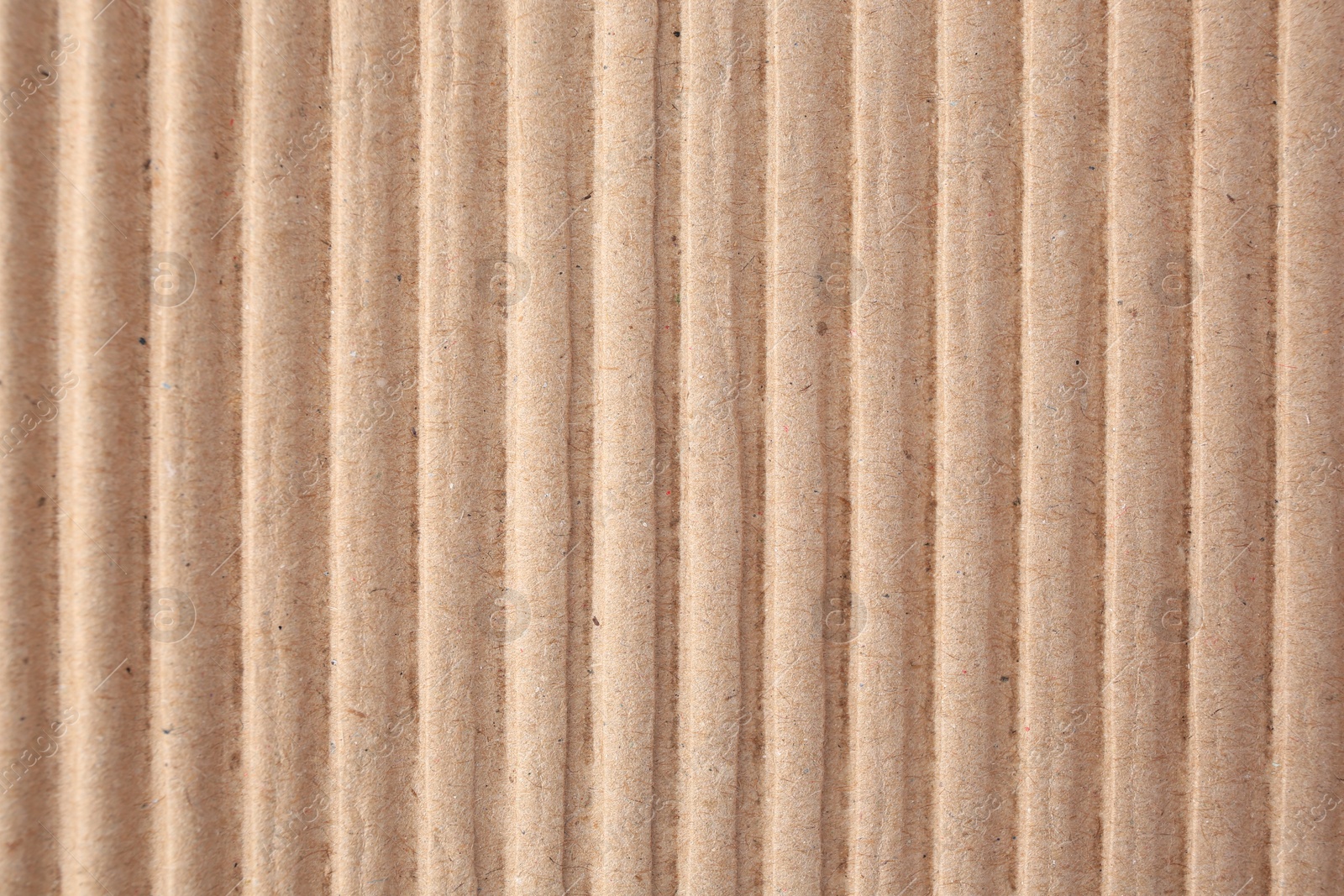 Photo of Texture of beige corrugated paper sheet as background, closeup