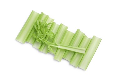 Photo of Fresh cut celery stalks and leaves isolated on white, top view