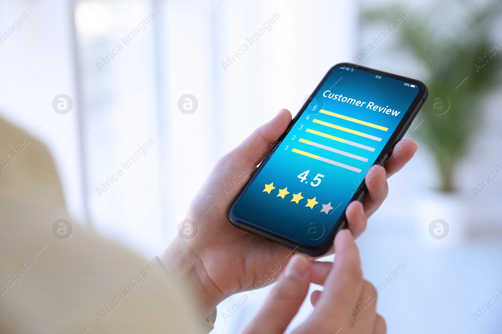 Image of Woman using smartphone to give feedback indoors, closeup. Customer review