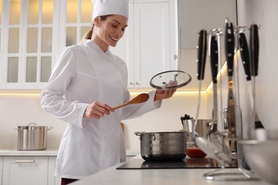 Professional chef cooking delicious dish in saucepan indoors