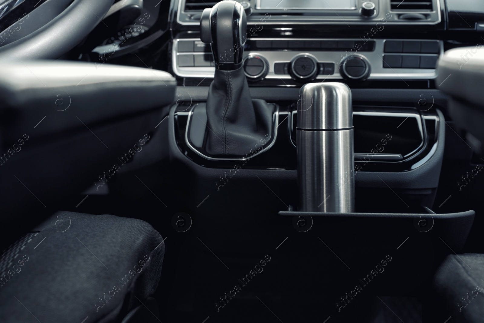 Photo of Silver thermos in holder inside of car