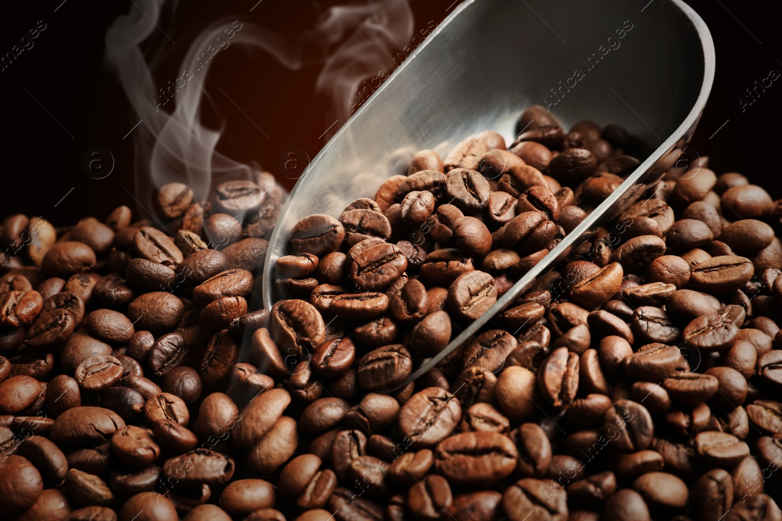 Image of Pile of roasted coffee beans and scoop, closeup