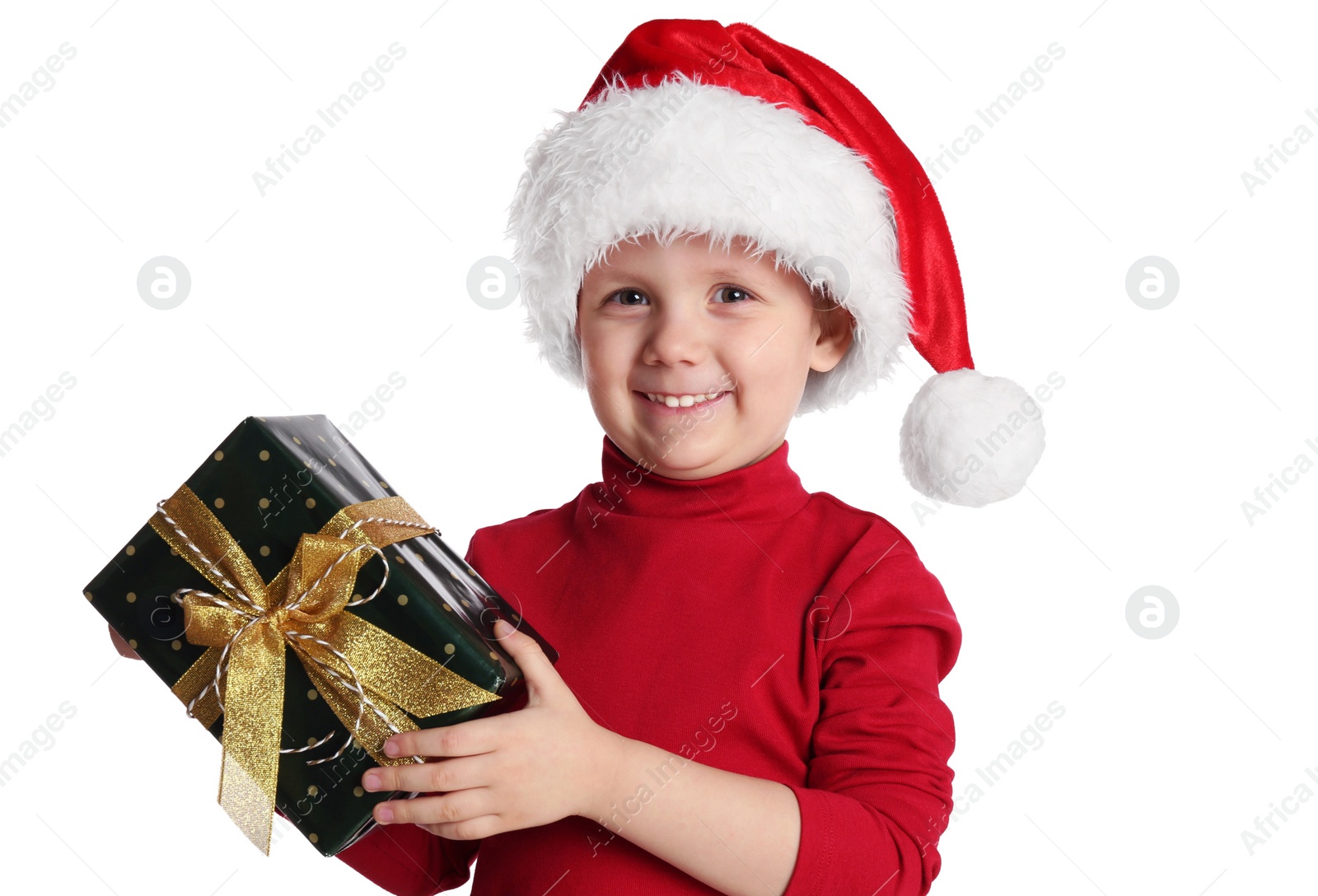 Photo of Cute child in Santa hat with Christmas gift on white background