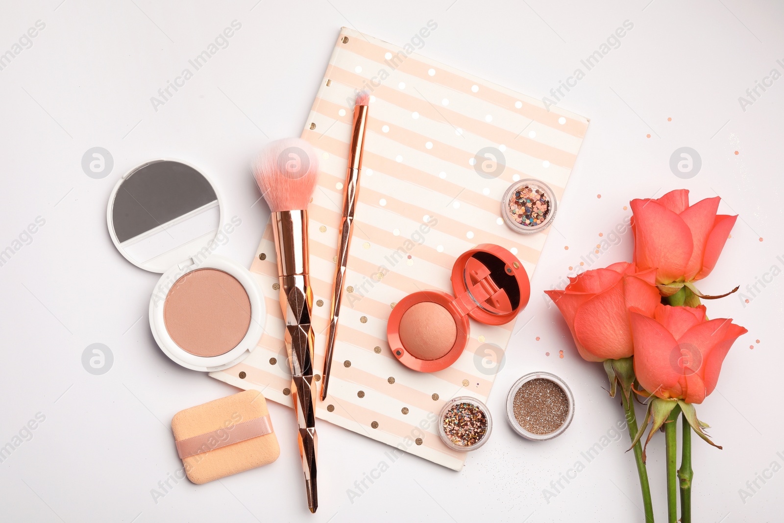 Photo of Flat lay composition with coral beauty accessories, notebook and roses on white background