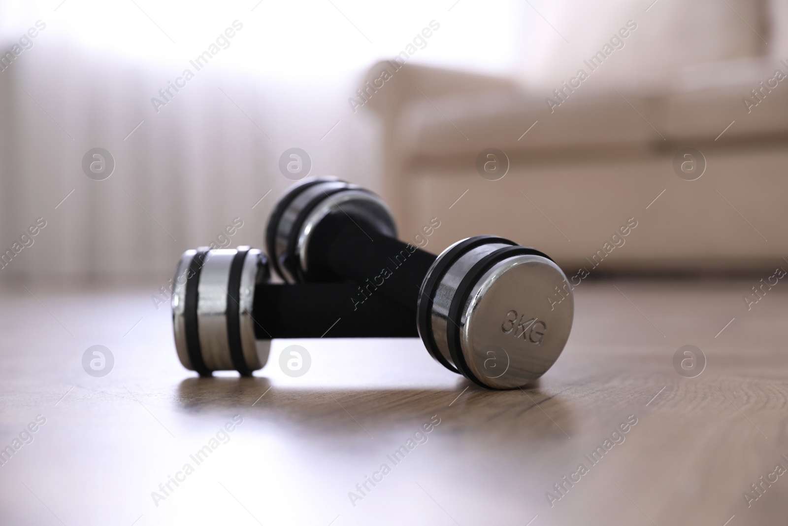 Photo of Dumbbells on floor in room. Home fitness