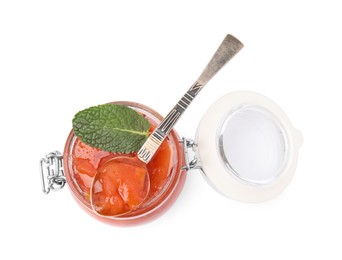 Jar and spoon of tasty persimmon jam with mint isolated on white, top view