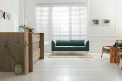 Photo of Hotel lobby interior with wooden reception desk. Stylish workplace