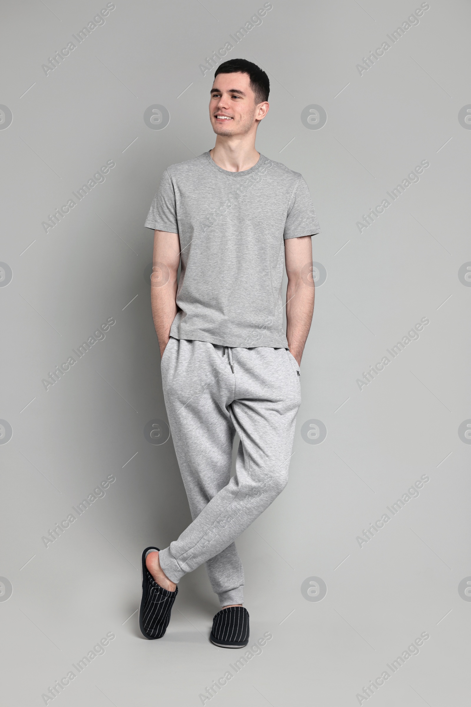 Photo of Happy man in pyjama on grey background