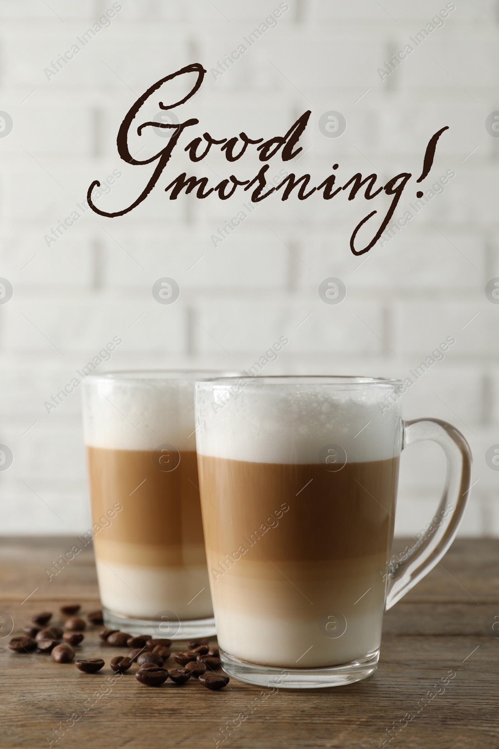 Image of Hot coffee with milk in glass cups and beans on wooden table. Good morning