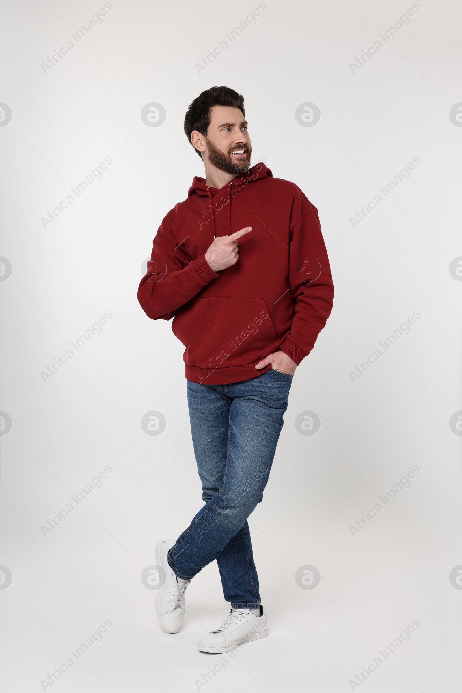 Photo of Happy man pointing at something on white background