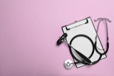 Photo of Reflex hammer, stethoscope and clipboard on pink background, flat lay with space for text. Nervous system diagnostic