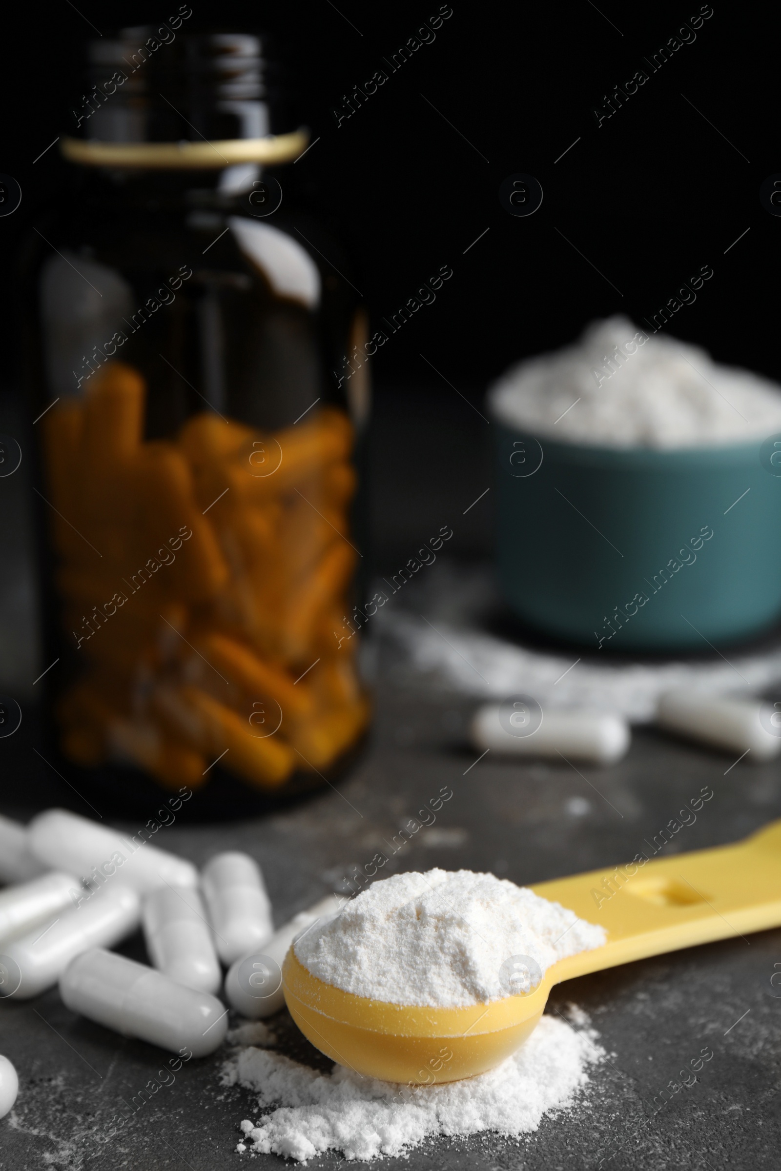 Photo of Amino acid pills and powder on grey table