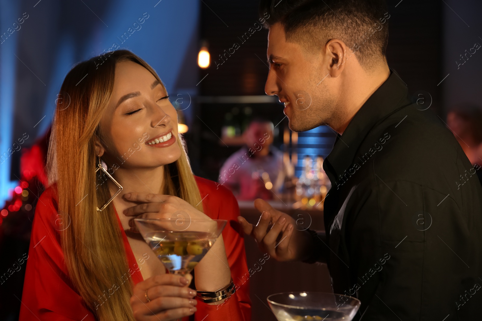 Photo of Man and woman flirting with each other in bar