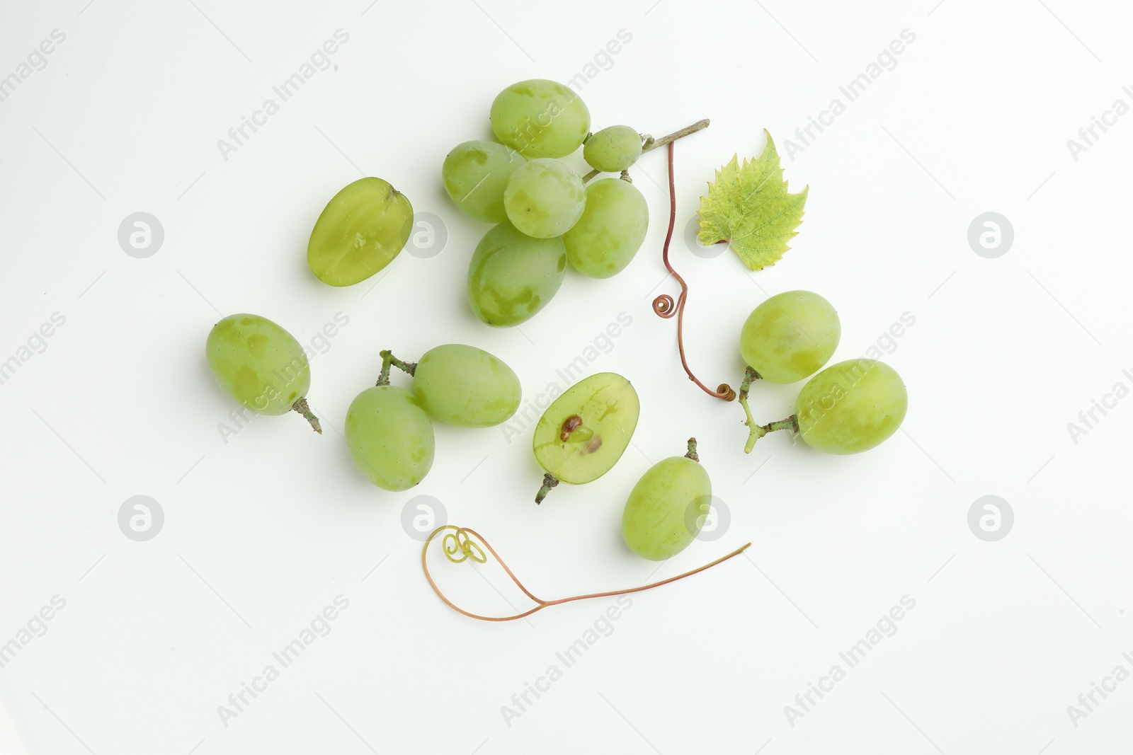 Photo of Fresh grapes and leaf on white background, top view
