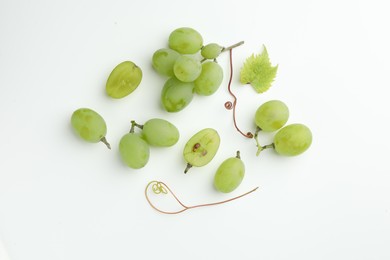 Photo of Fresh grapes and leaf on white background, top view