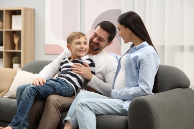 Pregnant woman spending time with her son and husband at home