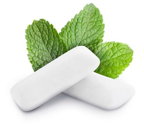 Image of Menthol chewing gum pillows and mint leaves on white background