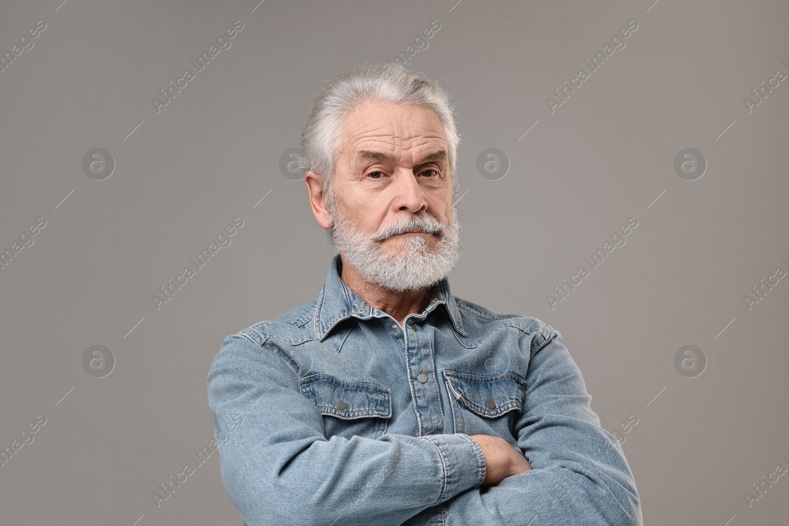 Photo of Senior man with mustache on grey background