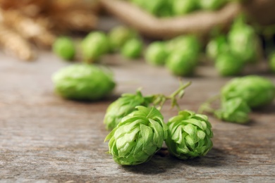 Photo of Fresh green hops on wooden table. Beer production