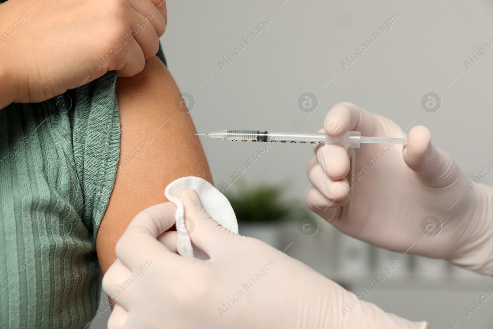 Photo of Doctor giving injection to patient in hospital, closeup. Vaccination day