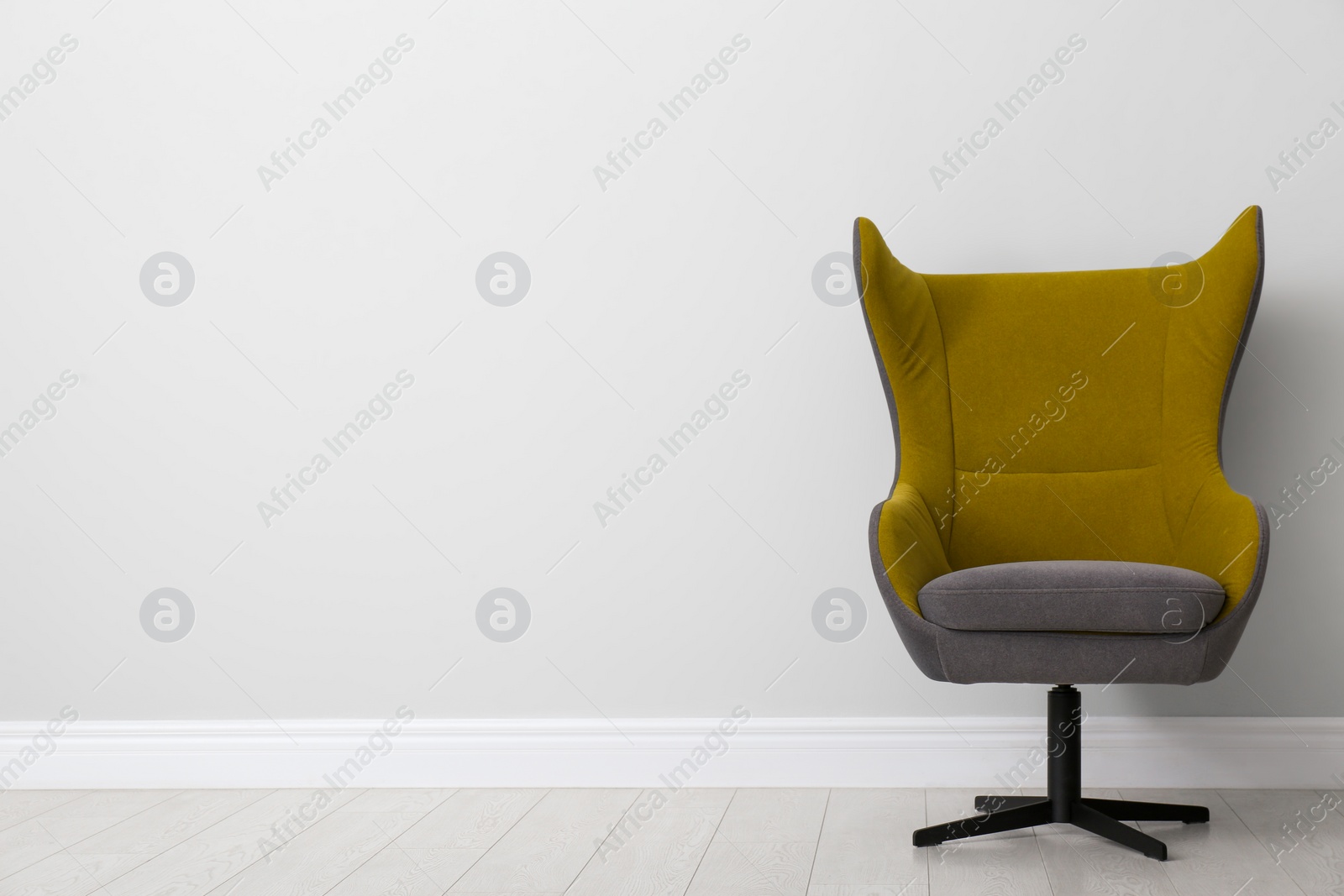 Photo of Comfortable office chair near light wall indoors. Space for text