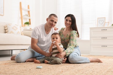 Photo of Portrait of happy family with little child at home