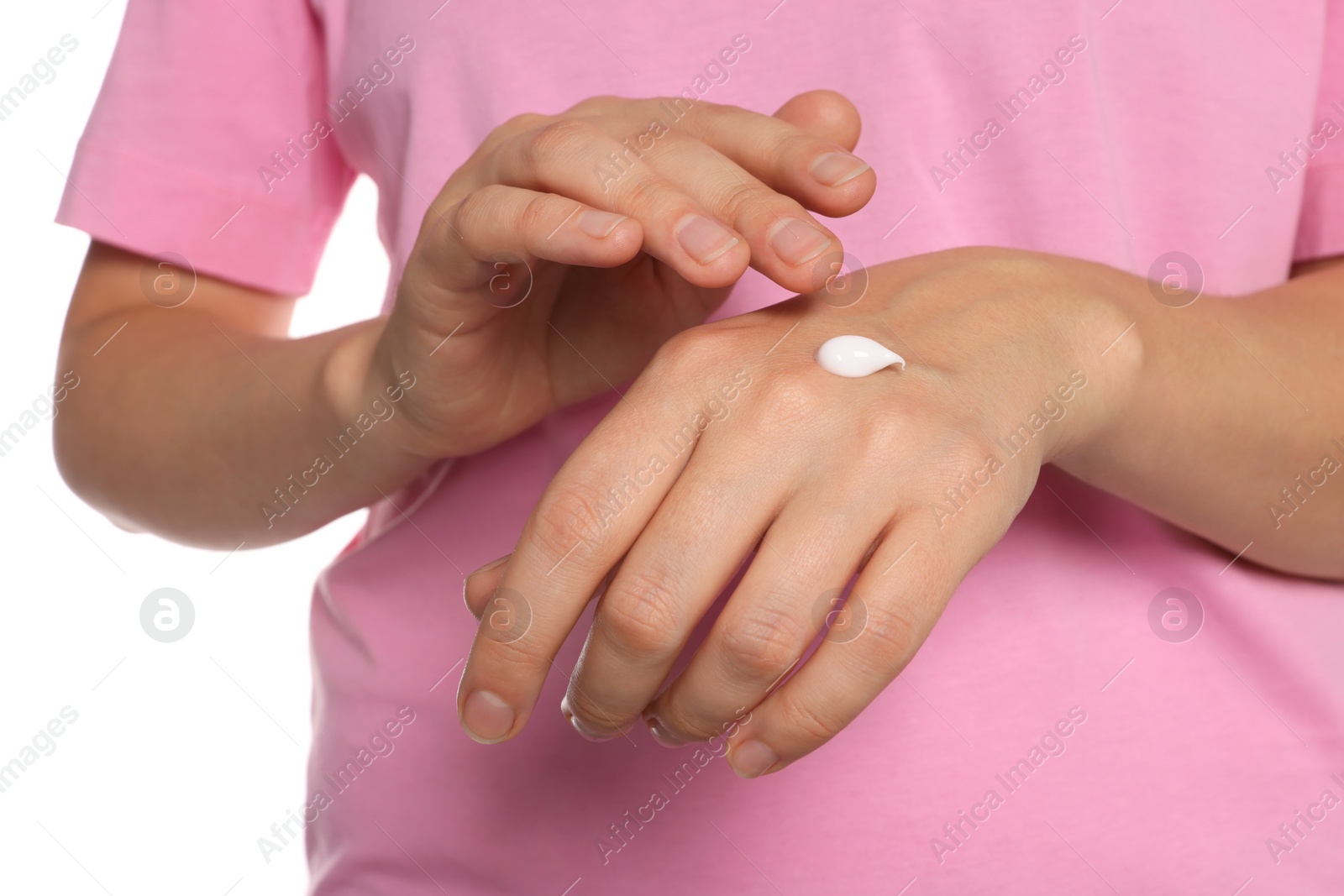 Photo of Woman applying cream on her hand against white background, closeup