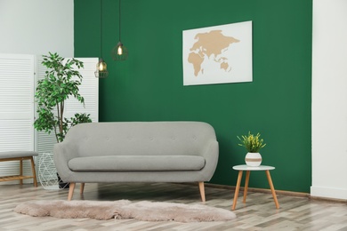 Photo of Modern interior with comfortable sofa near green wall