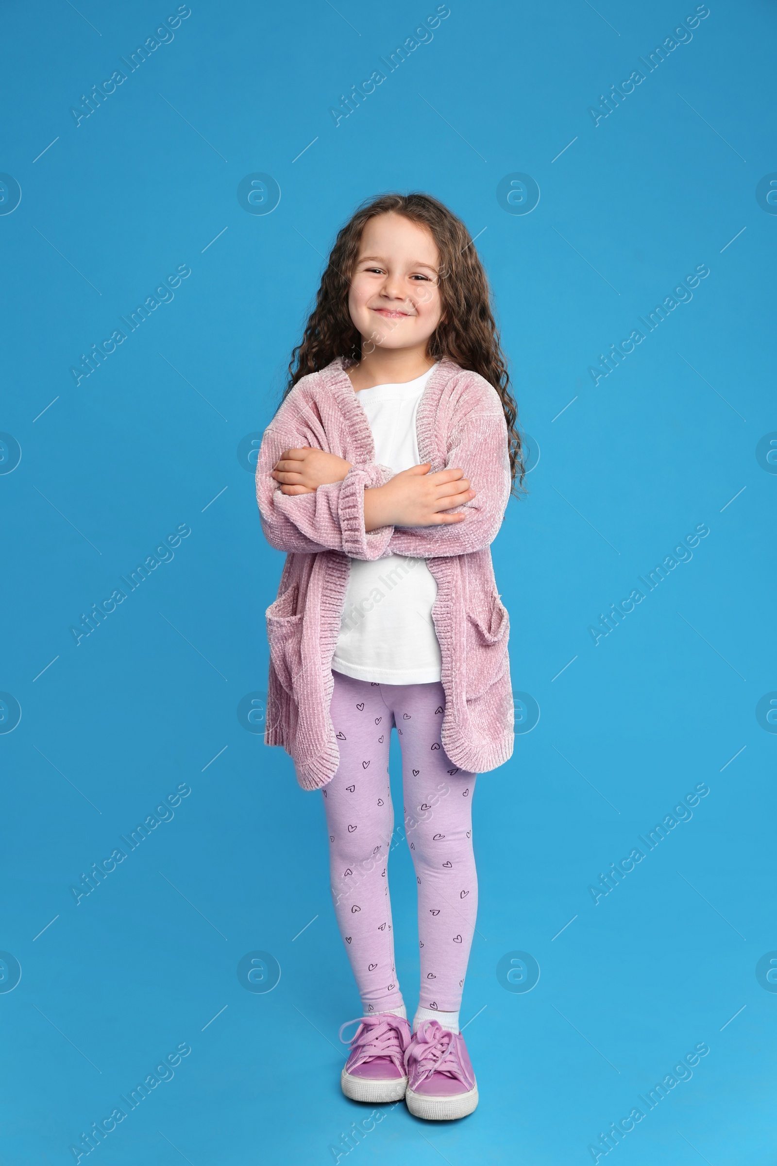 Photo of Full length portrait of cute little girl on light blue background