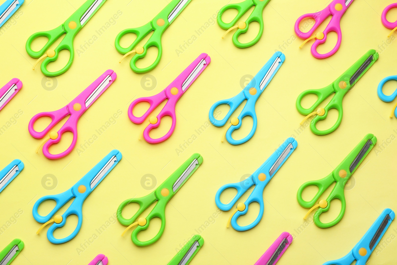 Photo of Set of training scissors on color background, flat lay