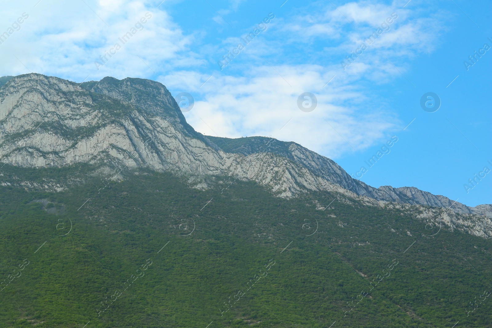 Photo of Majestic mountain landscape under blue sky with clouds