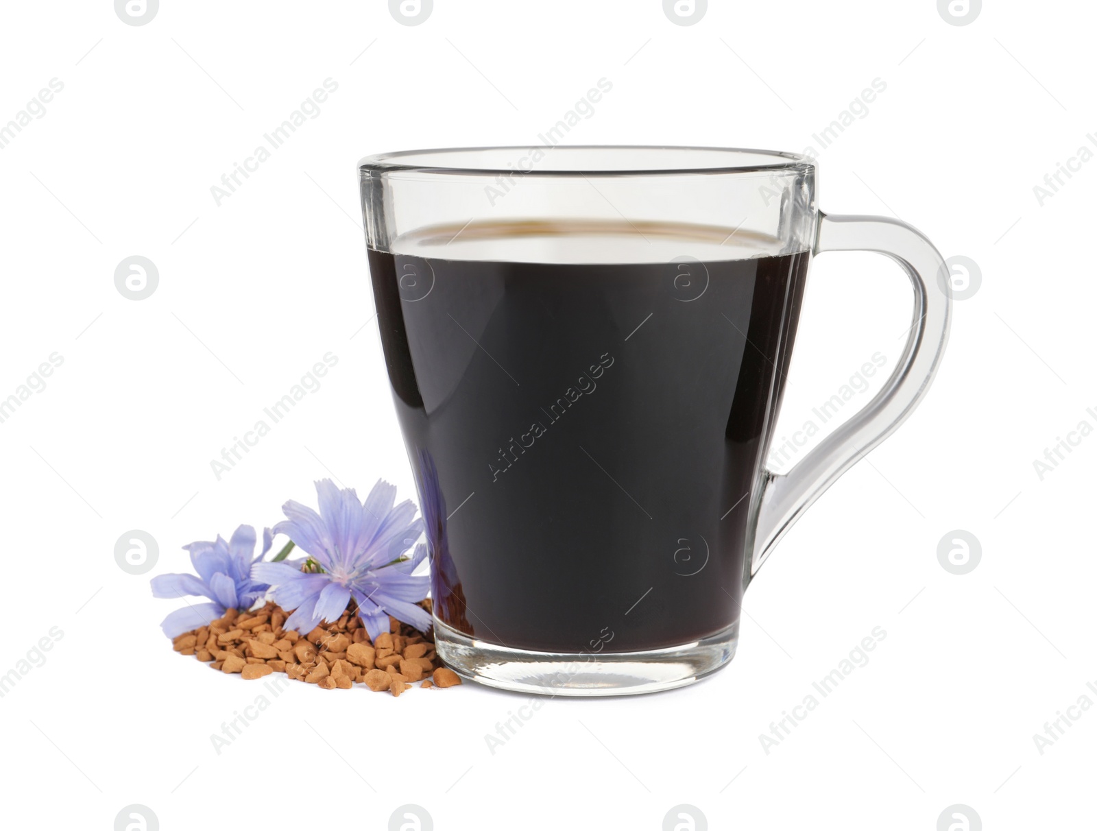Photo of Glass cup of delicious chicory drink, granules and flowers on white background