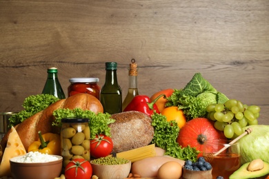 Photo of Different products on wooden background, closeup. Healthy food and balanced diet