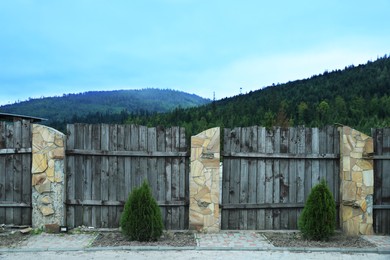 Photo of Beautiful view of mountain forest behind wooden fence