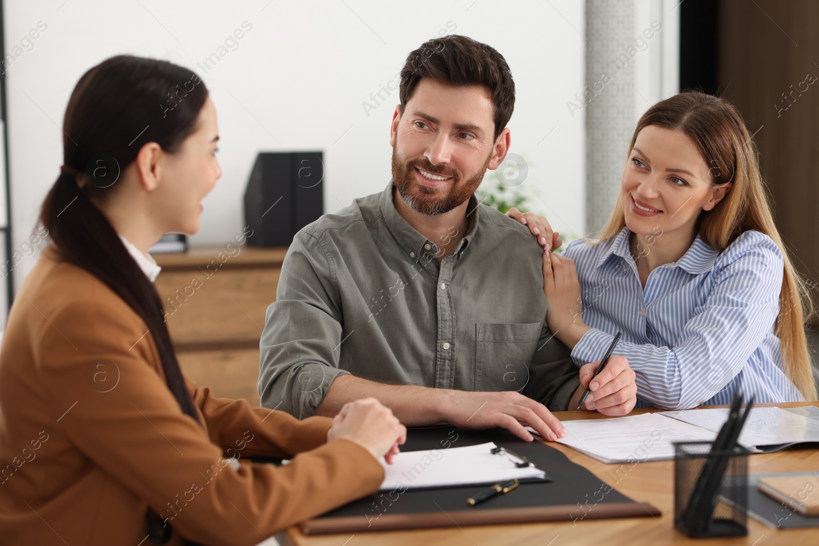 Photo of Couple having meeting with lawyer in office