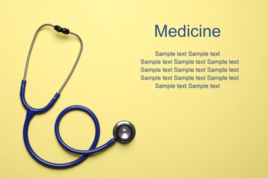 Stethoscope on yellow background, top view. Space for text