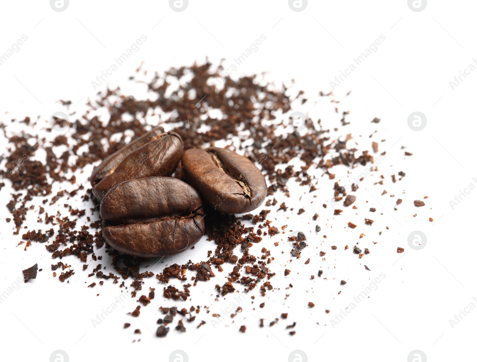 Photo of Coffee grounds and roasted beans on white background