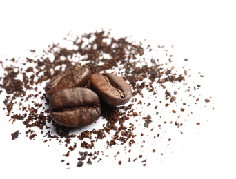 Coffee grounds and roasted beans on white background