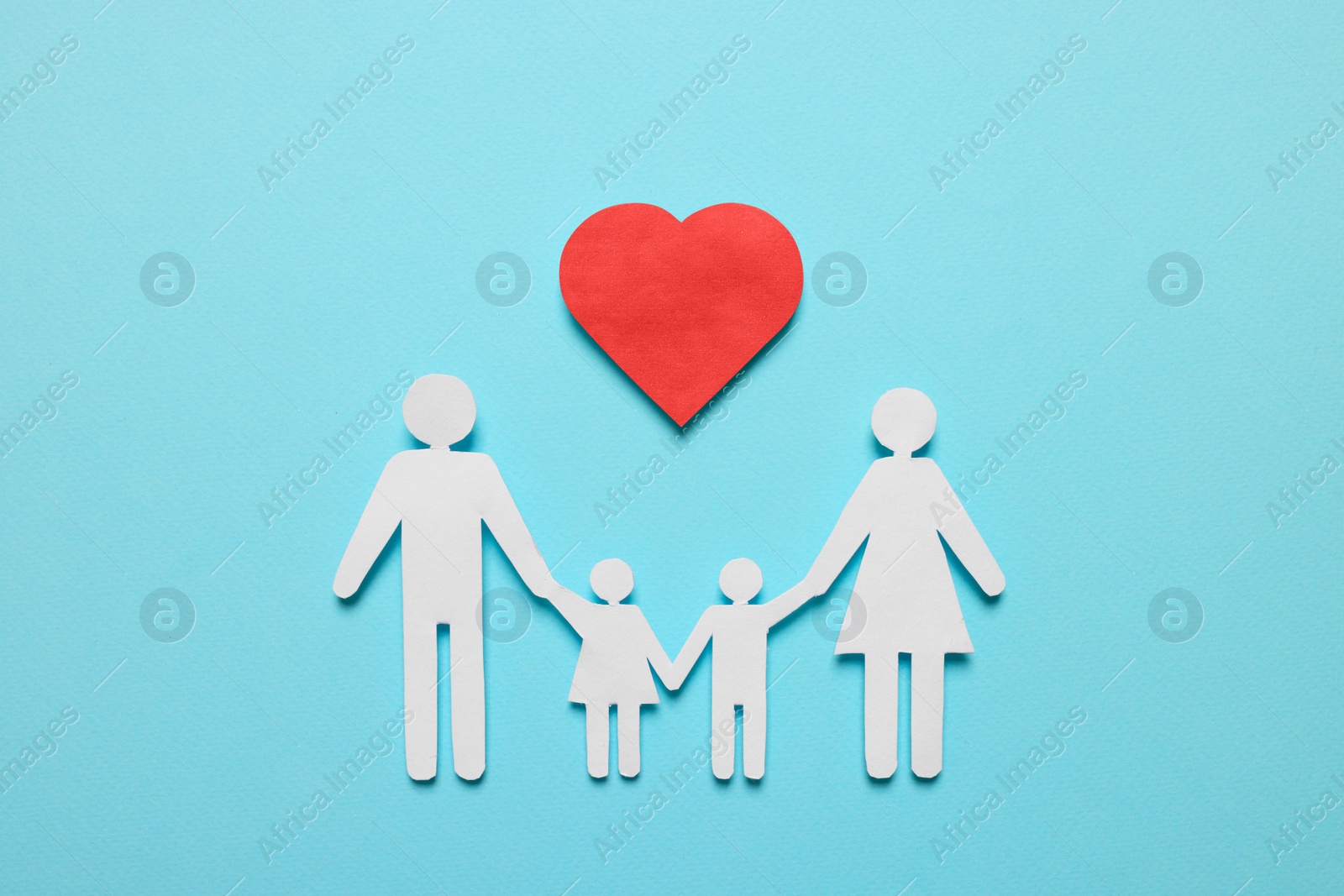 Photo of Paper family figures and red heart on light blue background, flat lay. Insurance concept