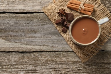 Photo of Flat lay composition with yummy hot chocolate on wooden table. Space for text