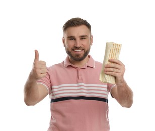 Young man with delicious shawarma on white background