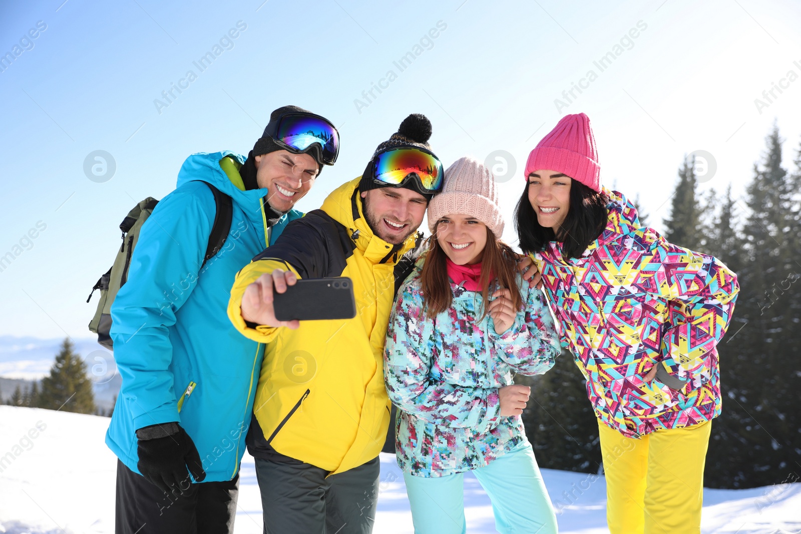 Photo of Group of friends taking selfie outdoors. Winter vacation