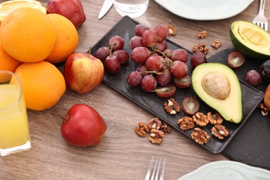 Healthy vegetarian food and glass of juice on wooden table